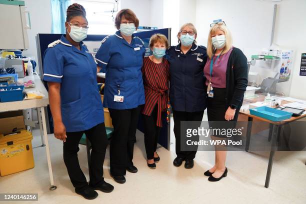 Margaret Keenan poses with staff after receiving her spring Covid-19 booster shot at University Hospital Coventry on April 22, 2022 in Coventry,...