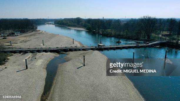 An aerial view taken on March 25, 2022 shows the Ponte delle Barche in Bereguardo, near Pavia, Lombardy, and the low water level of the Ticino river....