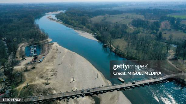 An aerial view taken on March 25, 2022 shows the Ponte delle Barche in Bereguardo, near Pavia, Lombardy, and the low water level of the Ticino river....