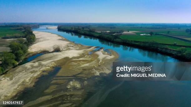 An aerial view taken on March 25, 2022 near the Ponte della Becca bridge in Vaccarizza, near Pavia, Lombardy, shows the low water level of the Po...