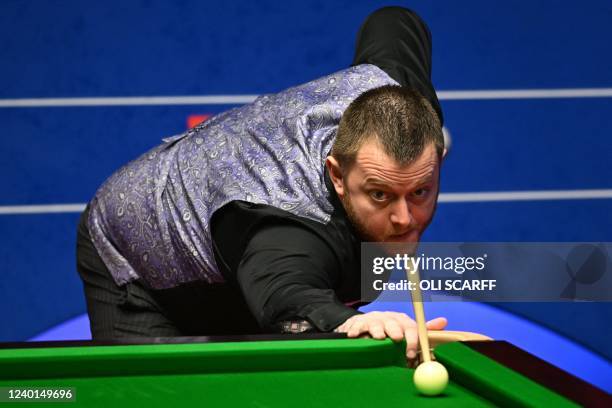Mark Allen of Northern Ireland plays a shot during the World Snooker Championship Round Two match against Ronnie O'Sullivan of England at the...