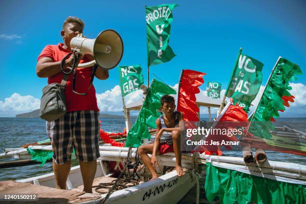 Fishermen and environment activists onboard a flotilla of boats sailed to the shores of Batangas bay to mark Earth Day and to protest the...