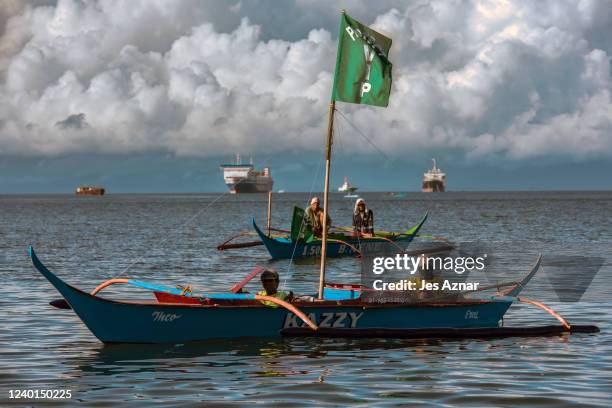 Fishermen and environment activists onboard a flotilla of boats sailed to the shores of Batangas bay to mark Earth Day and to protest the...