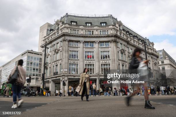 Pedestrians and shoppers cross the street at Oxford Street on April 22, 2022 in London, England. The country's Office of National Statistics reported...