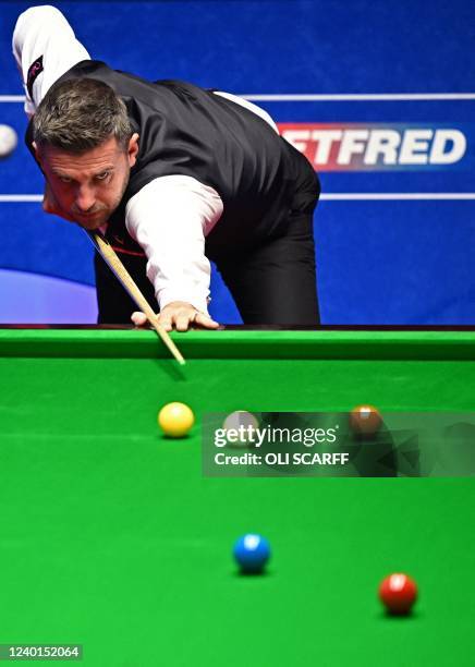 England's Mark Selby plays a shot against China's Yan Bingtao during their World Championship Snooker second round match at The Crucible in...
