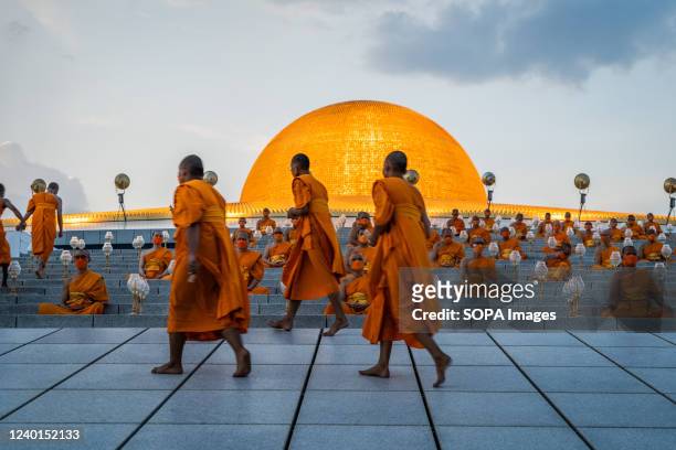 Monks walk up the side of Wat Phra Dhammakaya Temple before meditating as a part of the Earth Day 2022 celebration ceremony. Wat Phra Dhammakaya...