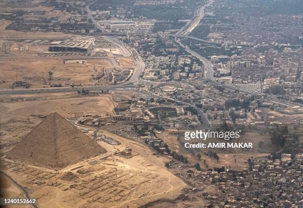 This picture taken on April 22, 2022 shows an aerial view of the Great Pyramid of Khufu and the under-construction Grand Egyptian Museum ,expected to...