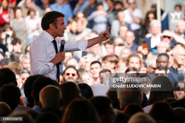 French President and centrist La Republique en Marche party candidate for re-election Emmanuel Macron speaks to supporters as he holds a rally on the...