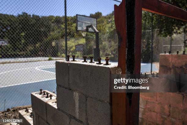 The remains of spectator stands beside a basketball court at Camp Hess Kramer, where much of the camp burned down during the 2018 Woolsey Fire, in...