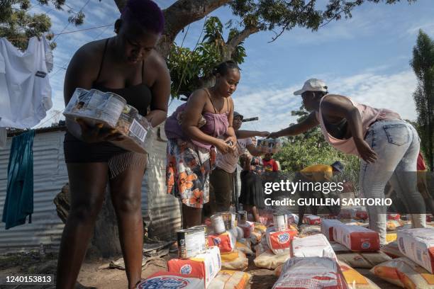 Housing activists and community members distribute food to people who've lost their homes in last weeks floods at the eNkanini informal settlment in...