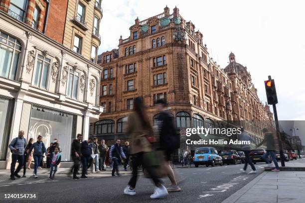 Pedestrians cross the street near Harrods luxury department store on April 22, 2022 in London, England. The country's Office of National Statistics...