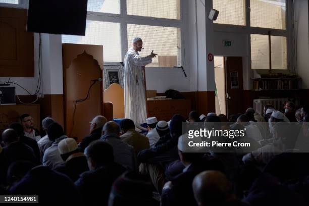 Muslim worshippers listen to the preach of an Imam during the Friday prayer at the mosque on the outskirts of Paris on April 22, 2022 in Ivry sur...