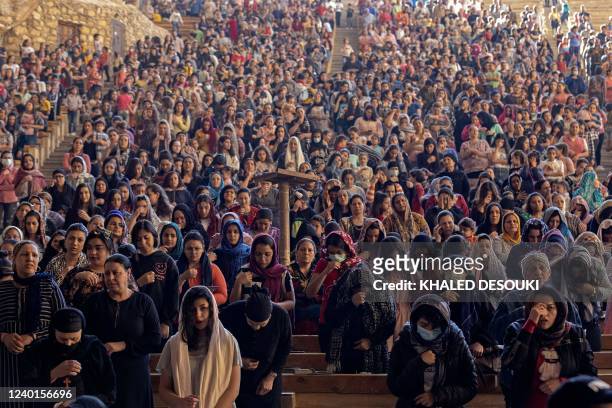 Coptic Orthodox Christians observe Good Friday prayers at the Saint Simon Monastery, also known as the Cave Church, in the Mokattam mountain of...