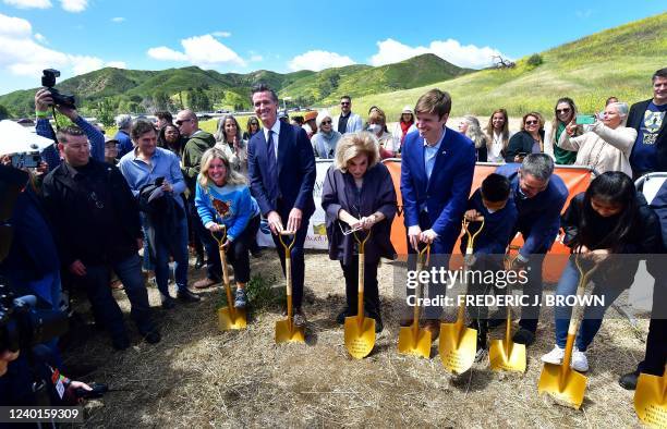 California Governor Gavin Newsom holds a shovel between wildlife advocate Beth Pratt and philanthropist Wallis Annenberg during the groundbreaking...