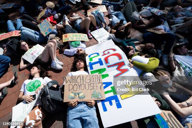 Climate change activists mark Earth Day with a die-in in Lafayette Square across from the White House in Washington on Friday, April 22, 2022....