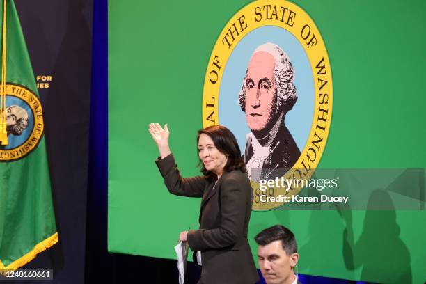 Sen. Maria Cantwell waves in front of the seal of Washington state as she takes the stage prior to U.S. President Joe Biden who will speak about the...