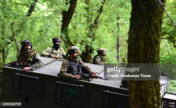 Security forces seen in armored vehicles at the site of an encounter at Malwah village on April 22, 2022 in Baramulla, India. Top commander of...