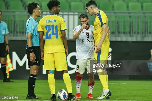 Gharafa's defender Mehdi Tahrat confronts Foolad's midfielder Moahammadreza Khalatbari during the AFC Champions League group C match between Iran's...