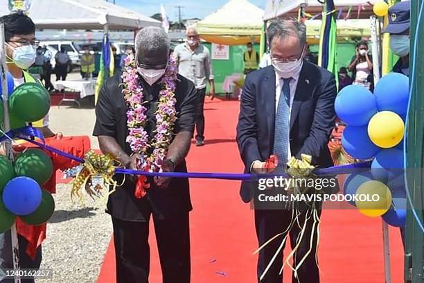 Photo taken on April 22, 2022 shows China's ambassador to the Solomon Islands Li Ming , and Solomons Prime Pinister Manasseh Sogavare cutting a...