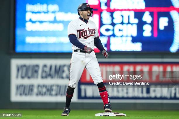 Carlos Correa of the Minnesota Twins celebrates reaching second base on two errors by the Chicago White Sox in the eighth inning of the game at...