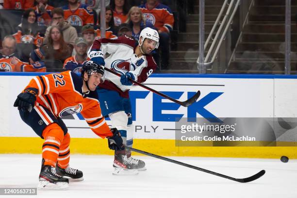 Tyson Barrie of the Edmonton Oilers skates against Nazem Kadri of the Colorado Avalanche during the third period at Rogers Place on April 22, 2022 in...