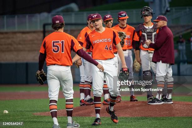 Virginia Tech Hokies pitcher Griffin Green receives a high five when coming out of the game in the eighth inning of a college baseball game between...