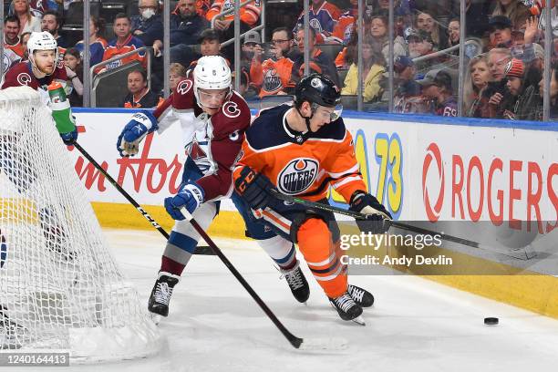 Ryan McLeod of the Edmonton Oilers battles for the puck against Cale Makar of the Colorado Avalanche on April 22, 2022 at Rogers Place in Edmonton,...