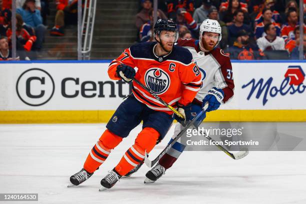 Edmonton Oilers Center Connor McDavid is checked by Colorado Avalanche Right Wing J.T. Compher in the first period during the Edmonton Oilers game...
