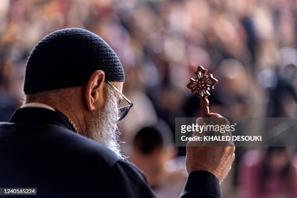 Coptic priest leads the mass as Orthodox Christians observe Good Friday prayers at the Saint Simon Monastery, also known as the Cave Church, in the...
