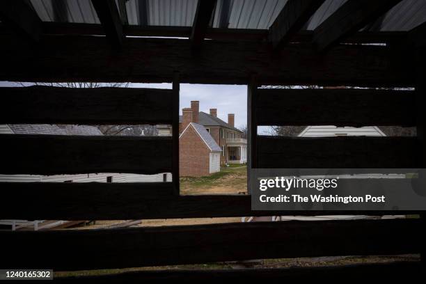 The Montpelier mansion is seen through the slats of a replica slave quarters Sunday, December 5, 2021.