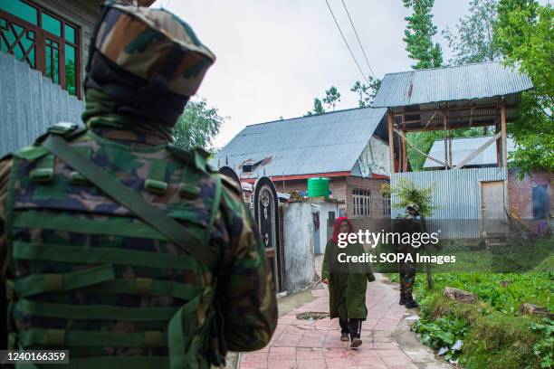 Indian forces stand on guard at a road that leads to the gunfight site in the Malwah area of North Kashmir's Baramulla District. Indian forces killed...