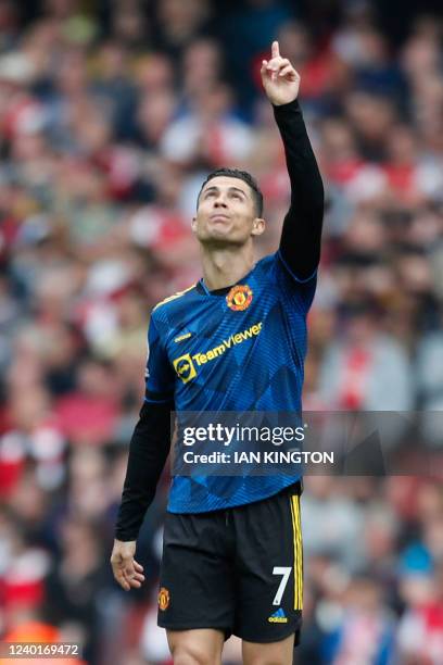 Manchester United's Portuguese striker Cristiano Ronaldo gestures after scoring their first goal during the English Premier League football match...