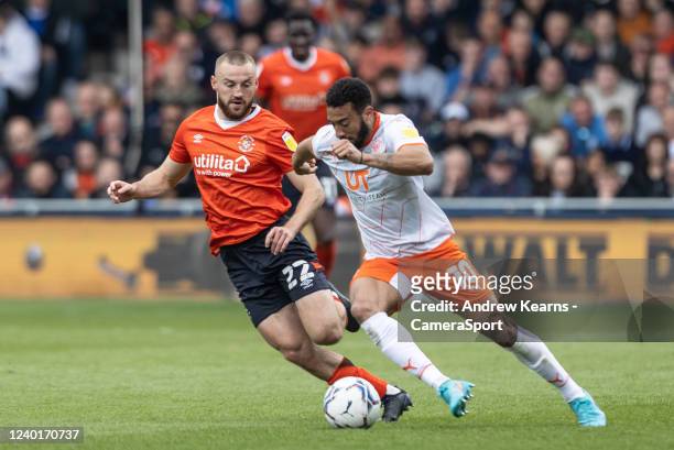 Blackpool's Keshi Anderson competing with Luton Town's Allan Campbell during the Sky Bet Championship match between Luton Town and Blackpool at...