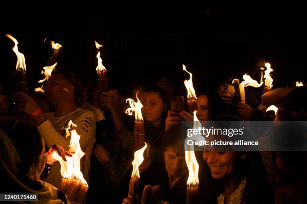 April 2022, Israel, Jerusalem: Orthodox Christian worshippers attend the Holy Fire ceremony at the Church of the Holy Sepulchre in Jerusalem's Old...