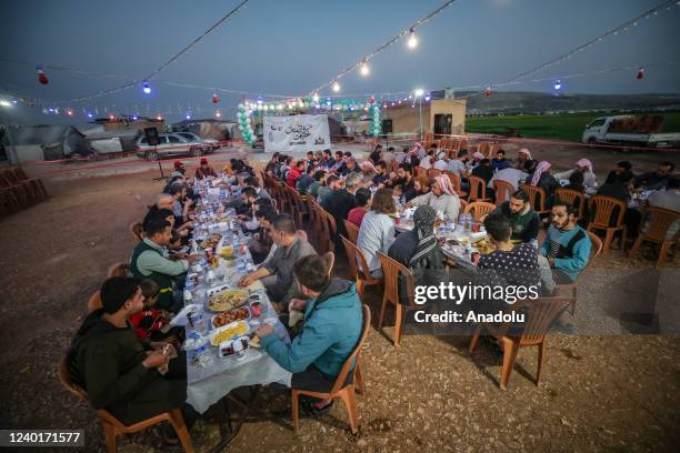 An iftar dinner is held for children living in camps where displaced civilians take shelter, during the holy month of Ramadan, in Idlib, Syria on...