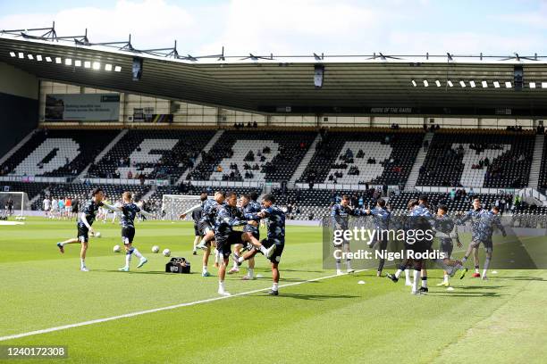 Derby County players warm up ahead of the Sky Bet Championship match between Derby County and Bristol City at Pride Park Stadium on April 23, 2022 in...