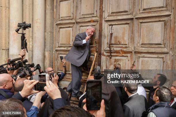 Custodian in charge of the ancient key to the Church of the Holy Sepulchre, unlocks the doors ahead of the Holy Fire ceremony in Jerusalem's old...
