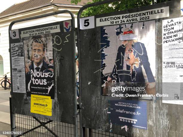 Defaced posters of both Presidential candidates, Emmanuel Macron and Marine Le Pen in front of a voting centre, on April 23, 2022 in Paris, France....