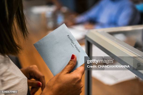 Voter casts a ballot during the second round of the French Elections at the French Consulate in Miami, Florida, on April 23, 2022. - France on...
