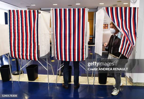 Voters mark their ballots in a polling booth during the second round of the French Elections at the French Consulate in New York, on April 23, 2022....