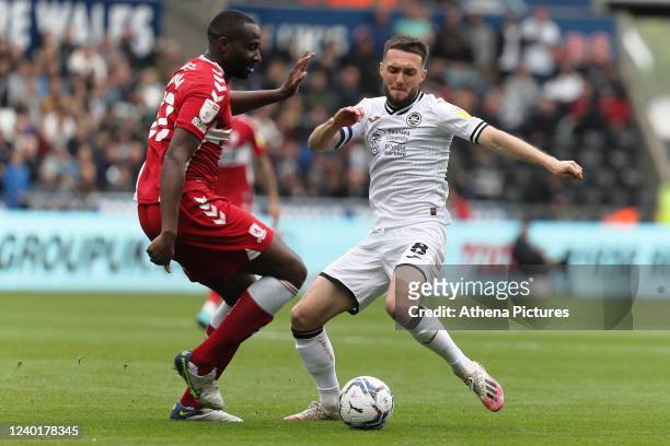 Sol Bamba of Middlesbrough challenged by Matt Grimes of Swansea City during the Sky Bet Championship match between Swansea City and Middlesbrough at...