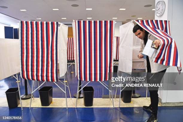 Voters mark their ballots in a polling booth during the second round of the French Elections at the French Consulate in New York, on April 23, 2022....