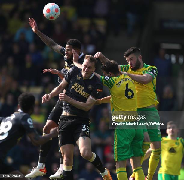 Grant Hanley and Christoph Zimmermann of Norwich City defend a free kick under pressure from Jamaal Lascelles and Dan Burn of Newcastle United during...