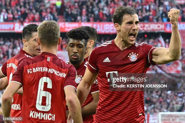 Bayern Munich's Polish forward Robert Lewandowski celebrates scoring the 2-0 goal with his teammates Bayern Munich's German midfielder Joshua...