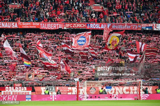 April 2022, Bavaria, Munich: Soccer: Bundesliga, Bayern Munich - Borussia Dortmund, Matchday 31, Allianz Arena.Bayern fans wave flags in the south...