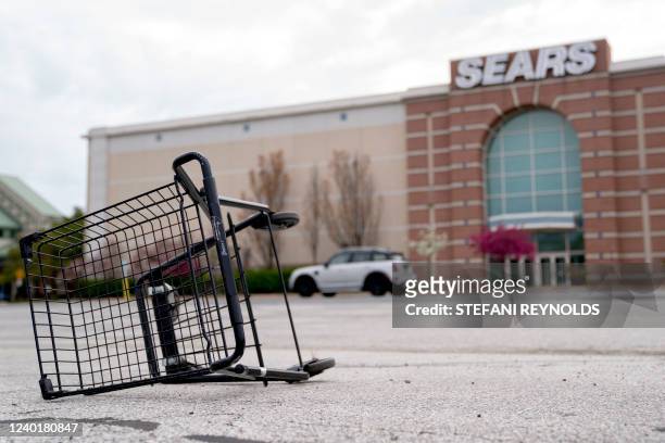 Shopping cart sits tipped over in the parking lot in front of a Sears store at Concord Mall in Wilmington, Delaware, on April 23, 2022.