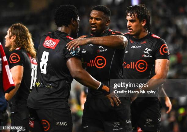 Durban , South Africa - 23 April 2022; Sikhumbuzo Notshe, centre, and Phepsi Buthelezi of Cell C Sharks embrace after their side's victory in the...