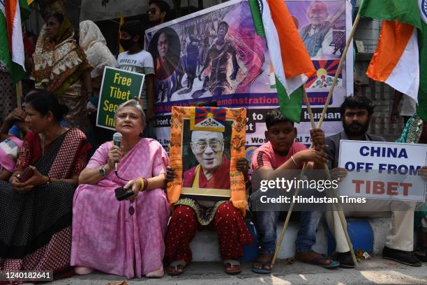 Supporters of the Dalai Lama seen with his portrait, posters, flags of Tibet and India, as they participate in a sit-in protest against China on...