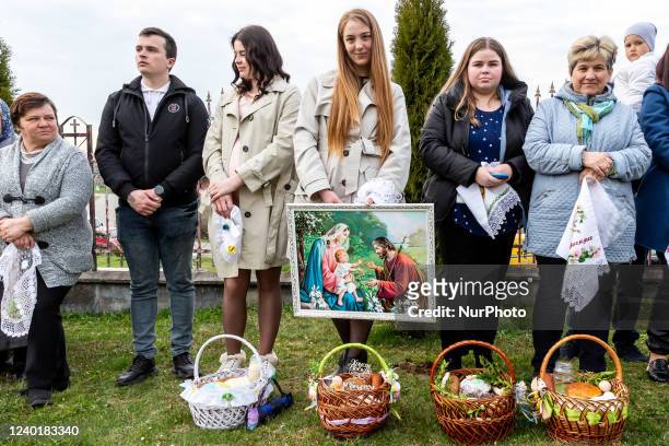 Ukrainian faithful attend Holy Saturday traditional food basket blessing ceremony in Greek-Catholic church in Nadyby, Lviv Oblast, Ukraine on April...