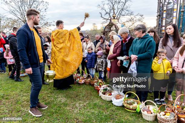Ukrainian faithful attend Holy Saturday traditional food basket blessing ceremony in Greek-Catholic church in Nadyby, Lviv Oblast, Ukraine on April...